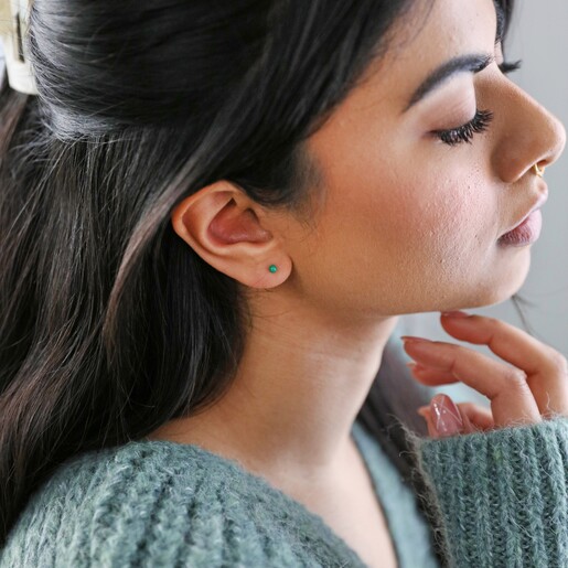 far away shot of side profile of model wearing Green Ball Stud Earrings in Gold