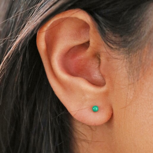 close up of model's ear wearing Green Ball Stud Earrings in Gold
