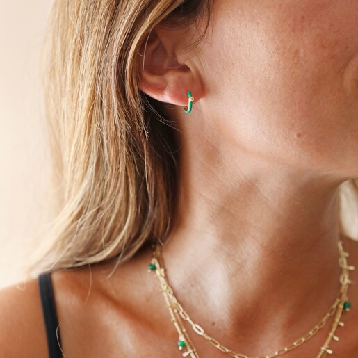 Model Wearing Green Enamel Crystal Huggie Hoop Earrings in Gold With Gold and Green Jewellery