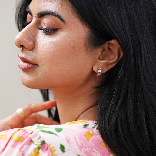 Model in Floral Dress Wearing Pink and Green Baguette Crystal Huggie Hoop Earrings