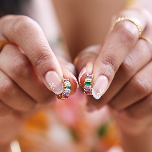 Model Holding Sparkling Pink and Green Baguette Crystal Huggie Hoop Earrings