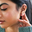 Red Ball Stud Earrings in Gold on model who is looking away from camera