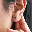 close up of model wearing Red Ball Stud Earrings in Gold