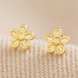 Tiny Flower Stud Earrings in Gold on Beige Fabric