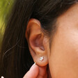 Model Wearing Tiny Flower Stud Earrings in Silver