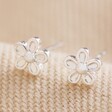 Tiny Flower Stud Earrings in Silver on Beige Fabric