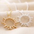 Crystal Sunburst Pendant Necklaces in Gold and Silver on Fabric