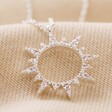 Crystal Sunburst Pendant Necklace in Silver on Beige Fabric