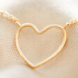 Close up of Figaro Chain and Heart Outline Necklace in Gold