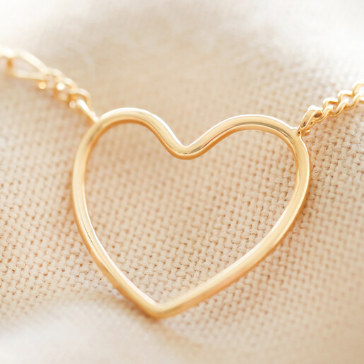 Close up of Figaro Chain and Heart Outline Necklace in Gold