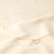 Full Length Figaro Chain and Heart Outline Necklace in Gold on fabric