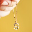 Model Holding Hammered S Charm Necklace in Gold