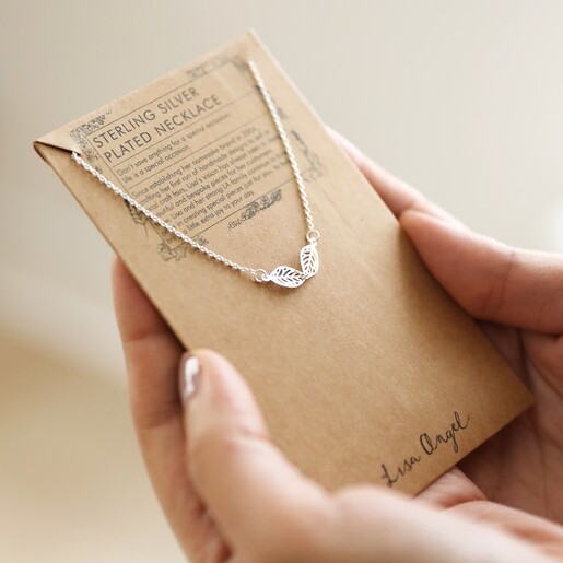 Close Up of Delicate Linked Filigree Leaf Necklace in Silver on packaging card