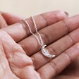 Model Holding Crystal Crescent Moon Necklace in Silver