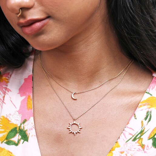 Model Wearing Crystal Sunburst Pendant Necklace in Gold with Moon Necklace