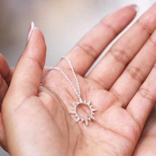 Model Holding Necklace Model Holding Crystal Sunburst Pendant Necklace in Silver