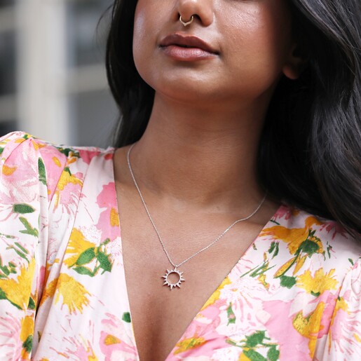 Necklace on Model Model in Floral Dress Wearing Crystal Sunburst Pendant Necklace in Silver