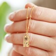 Model Holding Personalised Birth Flower Tiny Tag Pendant Necklace