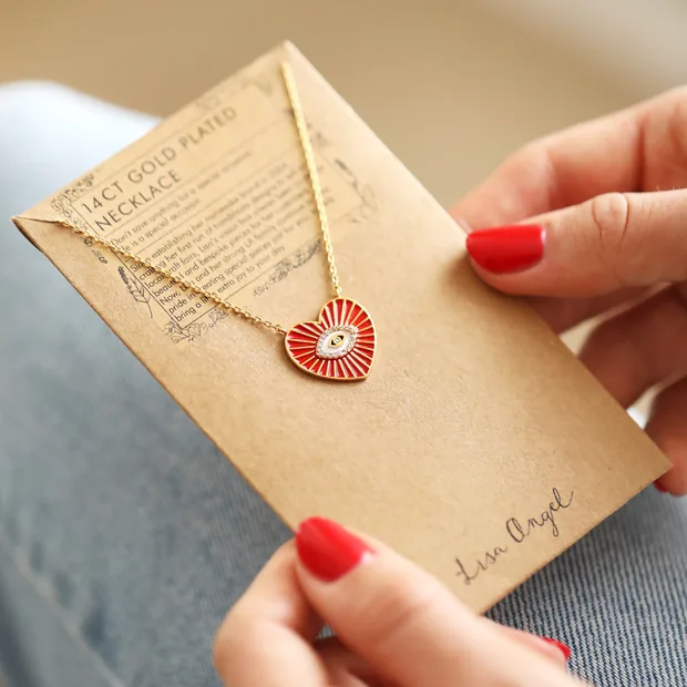 Model Holding Red Evil Eye Heart Pendant Necklace in Gold