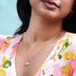 Small Flower Necklace with Pearl Centre in Gold on Model