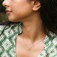 Model Wearing Tiny Butterfly Pendant Necklace in Gold