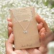 Model Holding Tiny Butterfly Pendant Necklace in Silver on Card