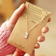 Model Holding Tiny Hammered Love Oracle Card Pendant Necklace in Packaging