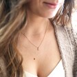 Female Model Wearing Tiny Pearl Initial Charm Necklace in Gold