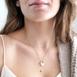 Model Wearing Personalised Tiny Pearl Initial and Heart Charm Necklace in Gold