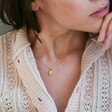 Model Wearing Crystal Hamsa Hand Necklace in Gold