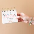 Model Holding Daily Yoga Poses Flip Chart