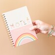 Model Holding Yoga Positivity Planner in front of Pink Background