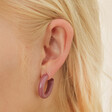Model Wearing Big Metal London Pack Of 2 Hoop Earrings in Purple