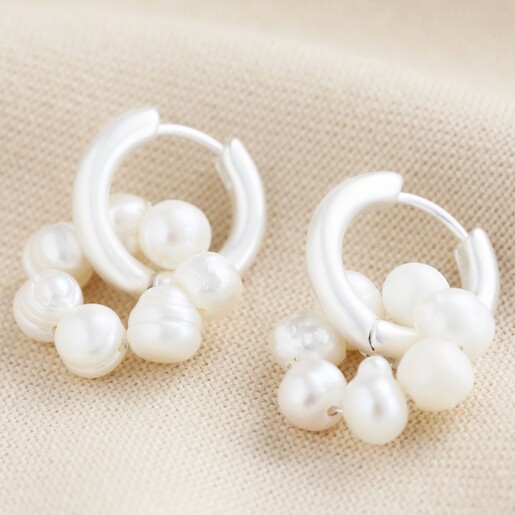 Big Metal London Pearl Daisy Hoop Earrings in Silver on Beige Fabric