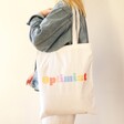 Model Carrying Personalised Rainbow Cotton Tote Bag in White on their shoulder