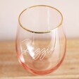 Empty Personalised Gold Rimmed Pink Tumbler on wooden table
