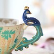 Close up of Handle of House of Disaster Luxe Peacock Mug