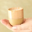 Model Holding Paddywax Pink Opal and Persimmon Glaze Ceramic Candle