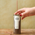 model placing lid on Paddywax Wild Mint & Santal 100 Incense Sticks
