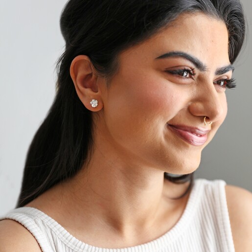Model wearing Estella Bartlett Silver Pearl Buttercup Stud Earrings