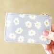 Model Holding Estella Bartlett Daisy Card Purse in Blue with happy travels showing