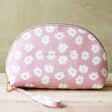 Estella Bartlett Little Things Daisy Half Moon Make Up Pouch in Pink sat on wooden table