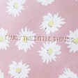 Close up of debossed enjoy the little things phrase on Estella Bartlett Little Things Daisy Half Moon Make Up Pouch in Pink