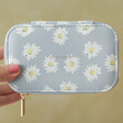 Model Holding Estella Bartlett Shiny Things Daisy Mini Jewellery Box in Blue in front of green background