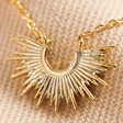 close up of Estella Bartlett Half Sunburst Necklace in Gold