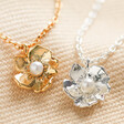 Gold and Silver Estella Bartlett Pearl Buttercup Necklaces on fabric