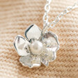 Close up of Estella Bartlett Silver Pearl Buttercup Necklace