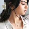 Model wearing Estella Bartlett Gold Pearl Buttercup Necklace