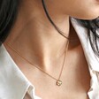 Close up of Estella Bartlett Gold Pearl Buttercup Necklace on model