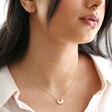 close up of Estella Bartlett Half Sunburst Necklace in Gold on model